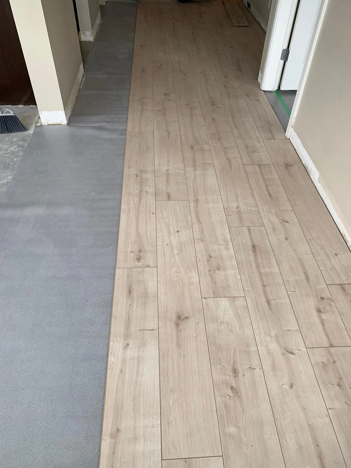 before/after photo of worn carpet replaced with vinyl plank
